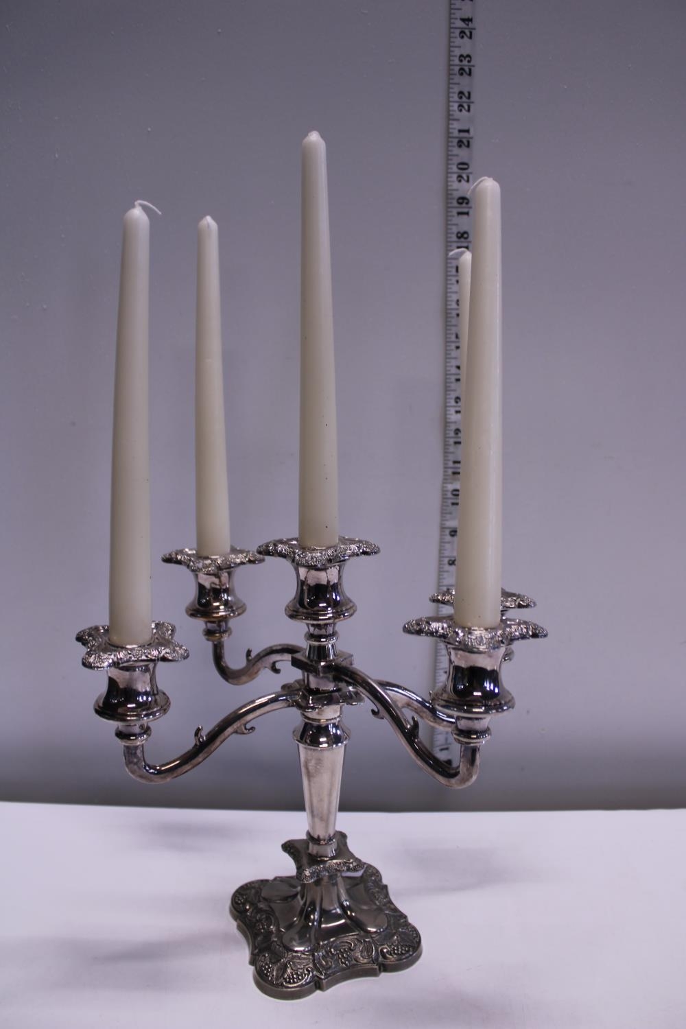 A silver plated four branch candelabra with candles