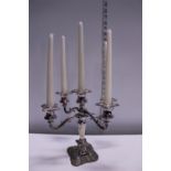 A silver plated four branch candelabra with candles