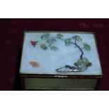 An unusual green jade box with brass mounts, decorated with trees & birds