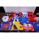 A box of assorted football shirts