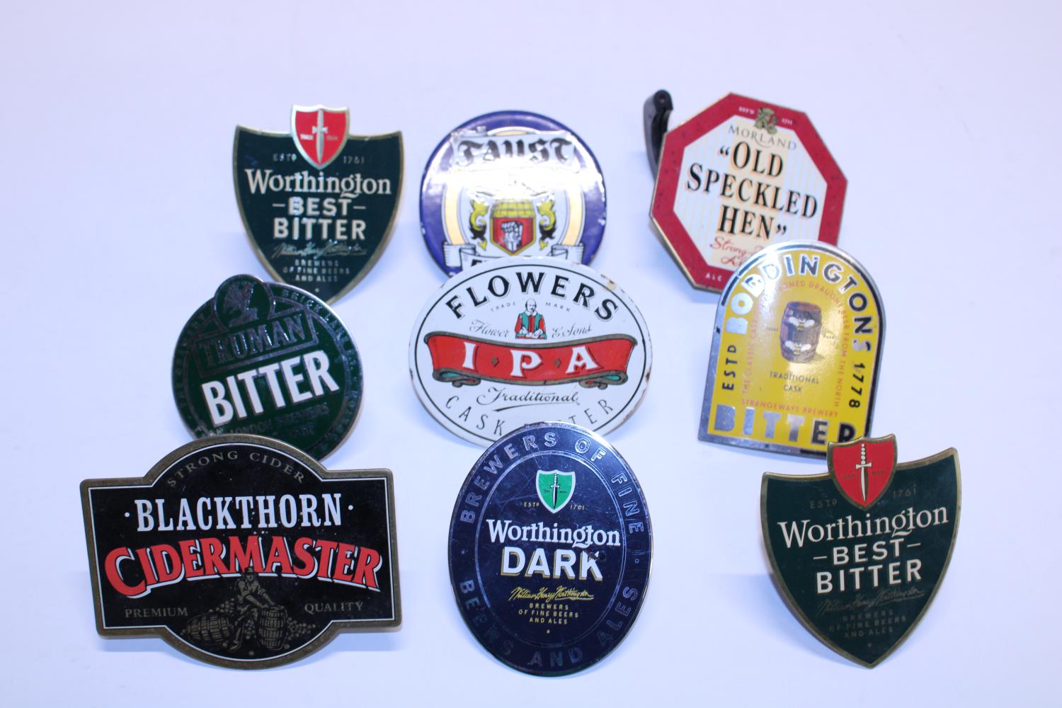 A selection of assorted metal beer pump labels