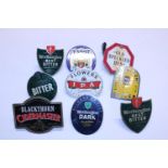 A selection of assorted metal beer pump labels