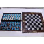 A set of wooden chess pieces complete with board
