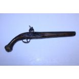 A antique 19th century large Ottoman Empire flintlock holster pistol with brass wire inlay