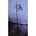 A wrought iron with a halothane glass shade floor lamp, shipping unavailable