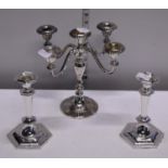 A silver plated candelabra and two silver plated candlesticks