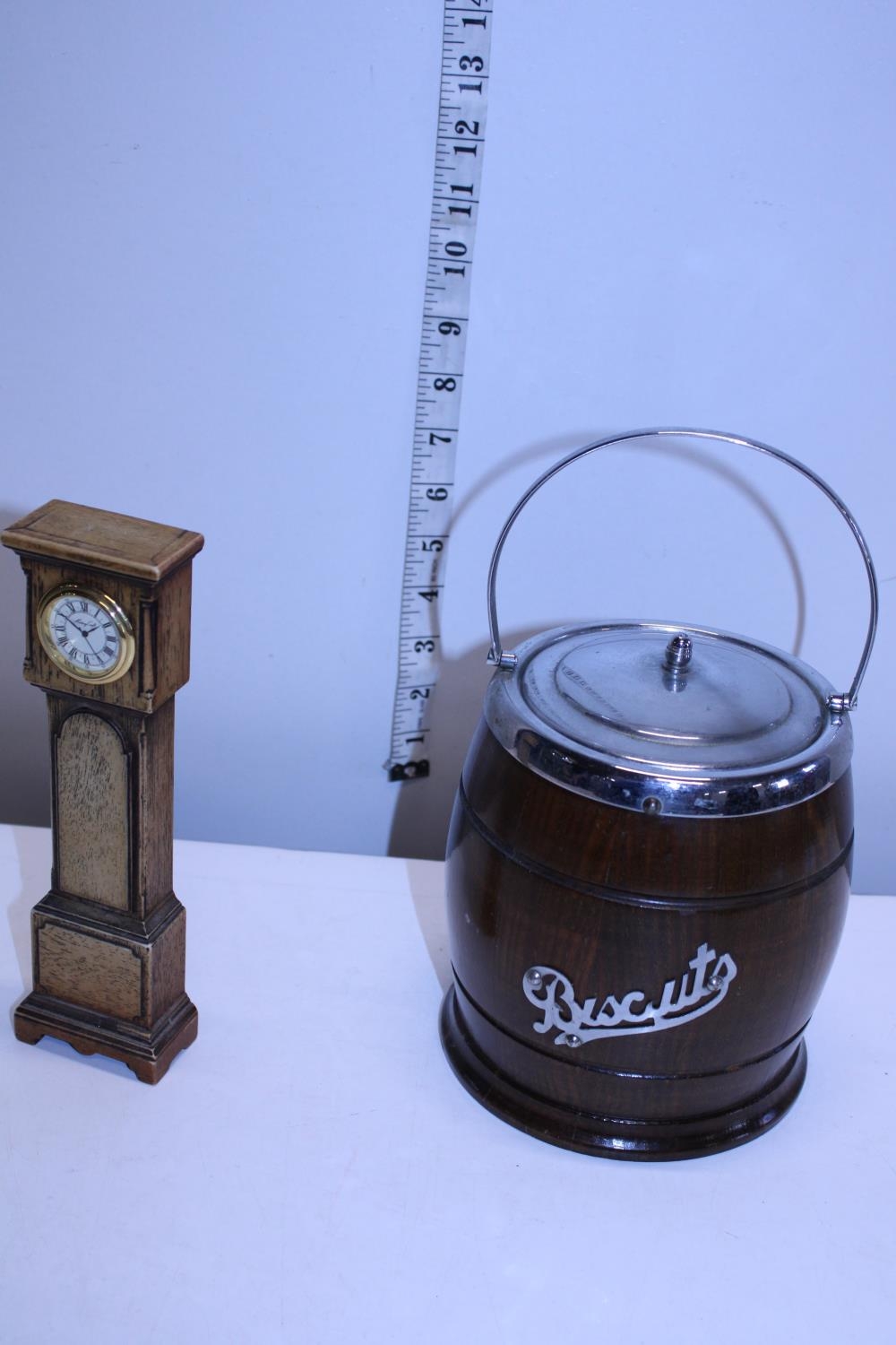 A novelty wooden grandfather clock and a oak and chrome biscuit barrel with enamel liner