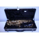 A cased Odyssey saxophone with mouthpiece etc