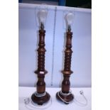 A pair of large wooden lamp bases, shipping unavailable