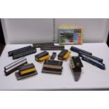 A box full of 00 gauge carriages and accessories