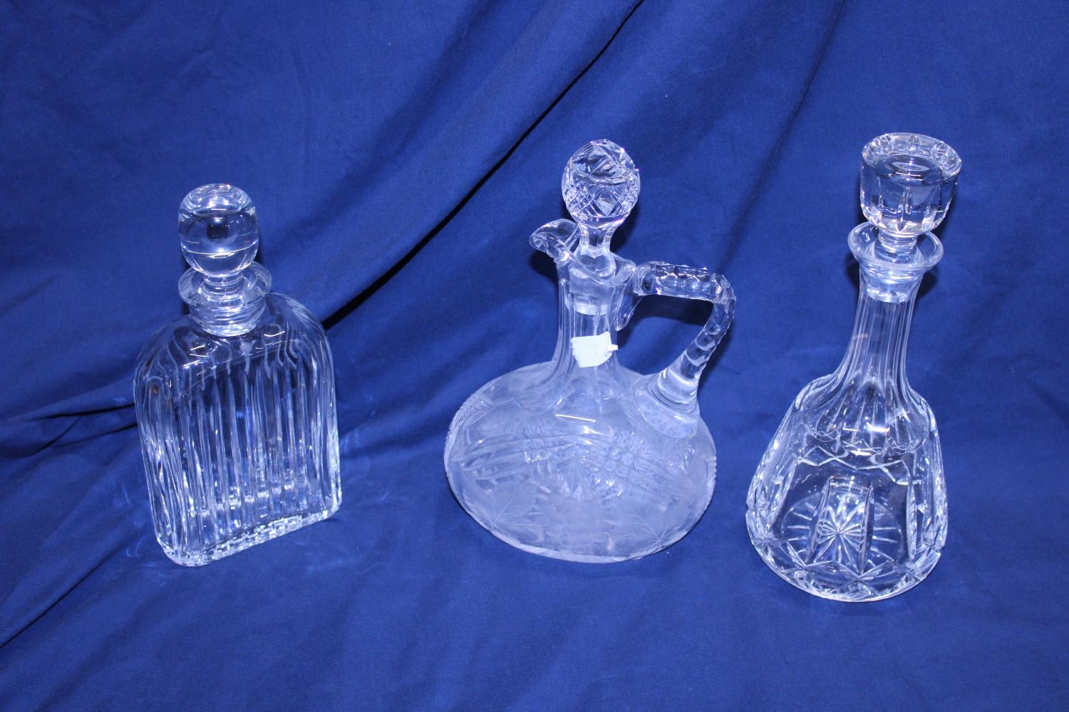 Three assorted cut glass decanters