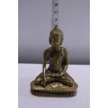 A brass figure of a seated Budda
