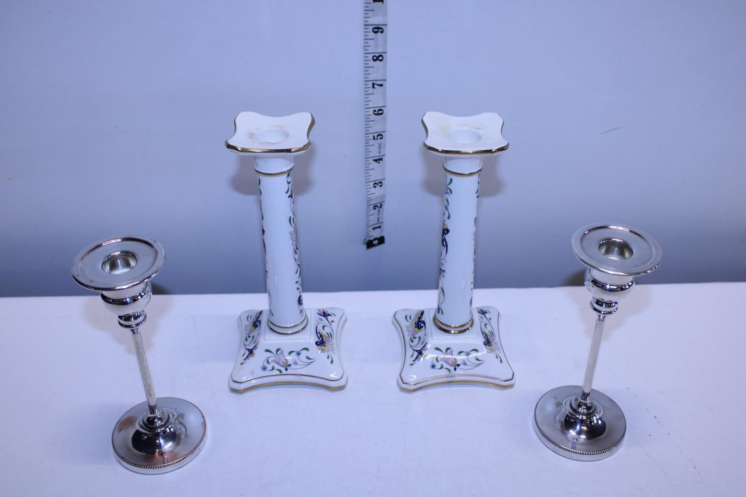 A pair of Coalport ceramic candlesticks and pair of silver plated candlesticks