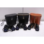 Three assorted pairs of binoculars