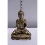 A brass figure of a seated Budda