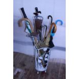 A vintage metal umbrella/stick stand and contents, shipping unavailable