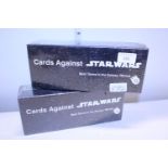 Two sealed boxes of Cards Against Star Wars