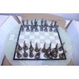 A good quality chess set with marble board and metal Greek mythical pieces