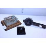 A Victorian cast iron squasher and two desktop items