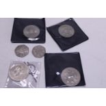 Four collectable £5 coins and two collectable 50p coins