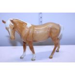 A large Beswick horse (missing one ear)