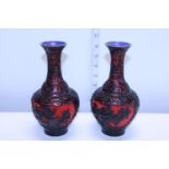 A pair of vintage black and red Chinese cinnabar lacquered vases with blue enamel decoration