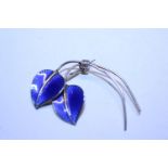 A 1950's Norwegian silver brooch with deep blue guilloche enamel by Hans Myhre, modelled as two