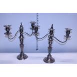 A pair of silver plate on copper vintage candelabras