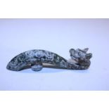A antique Chinese green jade belt hook in the form of a dragon