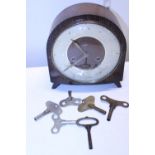 A wooden cased Smiths mantle clock with key in working order, shipping unavailable