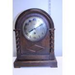 A wooden cased eight day mantle clock - no key