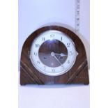 A working wooden cased mantle clock with key, shipping unavailable