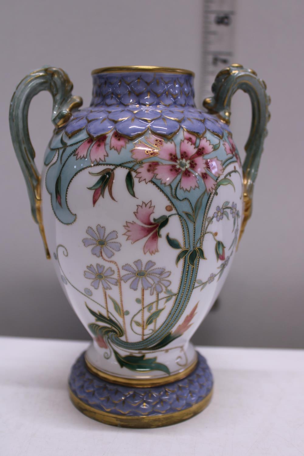 A hand decorated Royal Worcester two handled urn h15cm