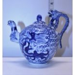 A Chinese porcelain dragon form blue and white teapot with character marks to the base