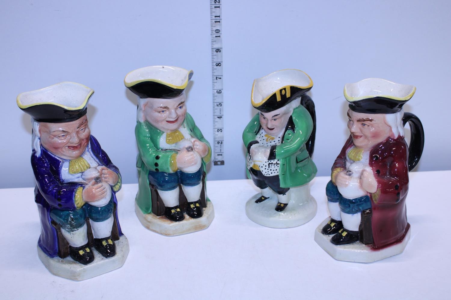 Four assorted large character jugs including Burlington examples