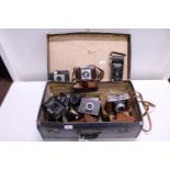 A vintage suitcase and contents of vintage cameras, shipping unavailable