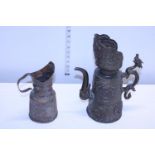 Two antique base metal jugs one with a dragon form handle possibly Tibetan
