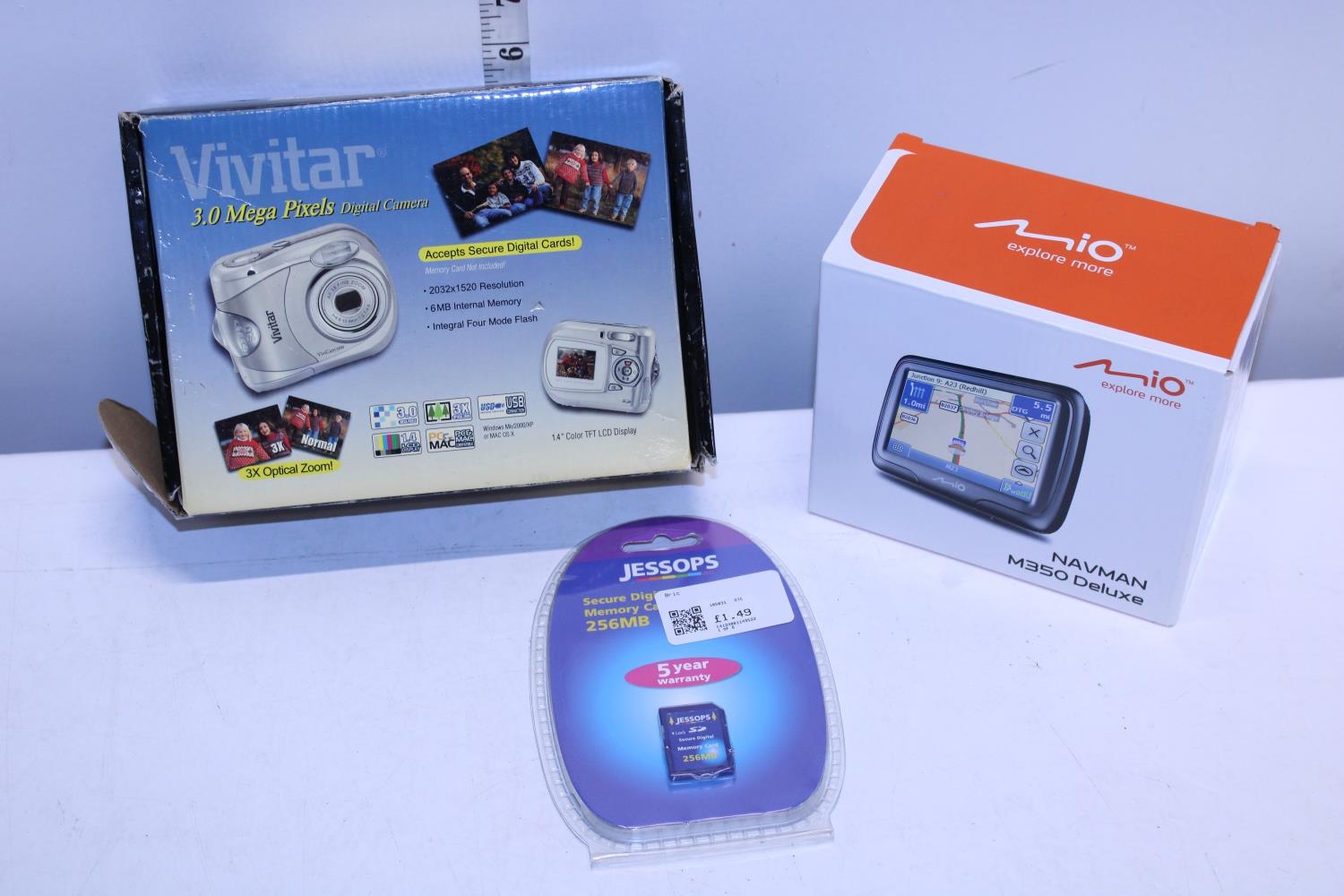 A boxed camera, a sat nav and new memory card (untested)