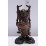 A hand carved Chinese laughing Budda on a Ebony stand 20cm