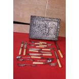 A vintage metal biscuit tin and contents of flatware