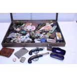 A table top display case with glazed panel and contents of assorted collectables, shipping