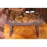 A antique wooden stool with inlay to seat
