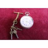 A ladies continental silver pocket watch with enamel dial and keys, works intermittently