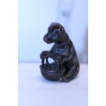 A small hand carved wooden dog figure