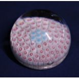A circa 1850 Bacchus paperweight with millefiori decoration with red and blue canes