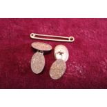 A pair of 9ct cufflinks and a 9ct gold tie pin 8g total weight