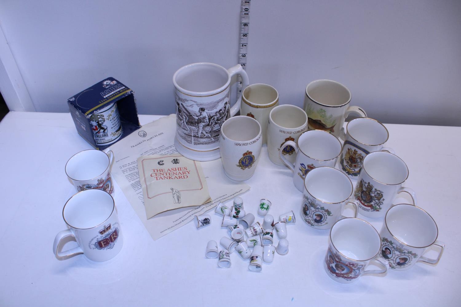A job lot of assorted commemorative ware mugs and other