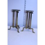 A pair of early 20th century shop display stands 26cm tall at shortest extension