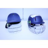 Two cricket helmets