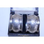 A cased set of two hallmarked silver napkin rings (Hallmarked for Chester)